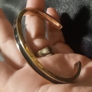 Vintage gold tone and black enamel cuff style bracelet. 7.5 adjustable